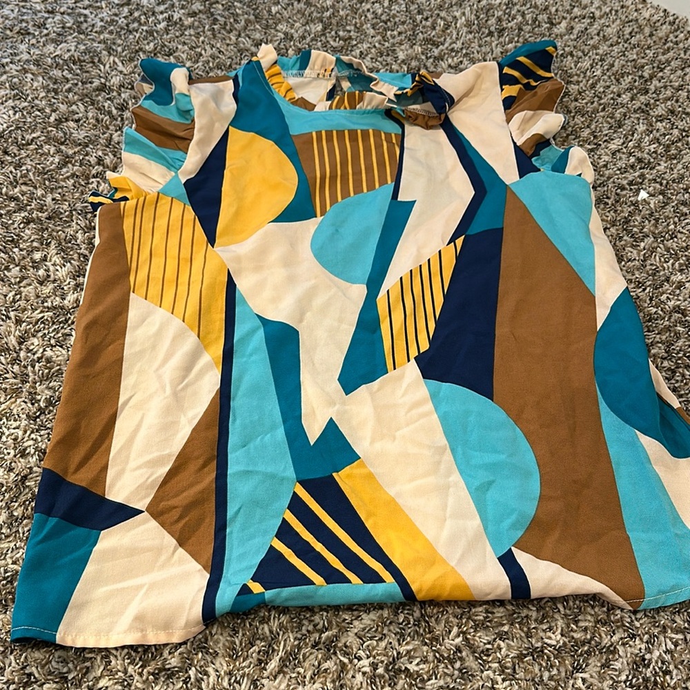 Printed patterns top. Wash but never worn. Small